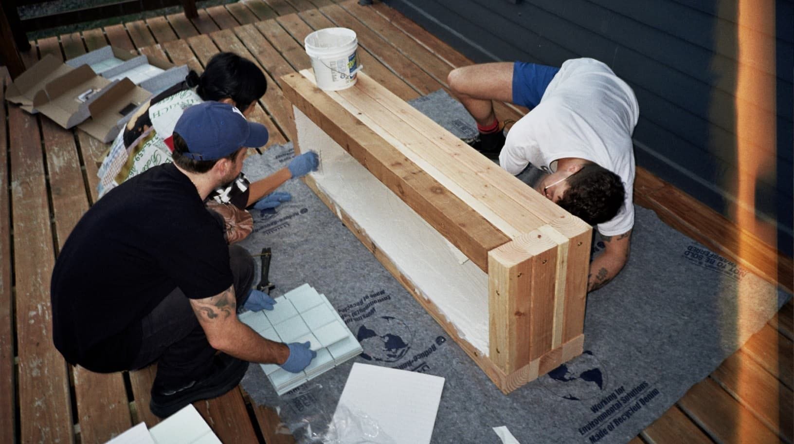 View Source's Annie Chen, Brendan McAuliffe and Andrew Rutledge constructing a bench out of wood and tile